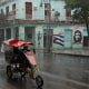 People pass by on the street as Hurricane Rafael passes by Havana, Cuba, November 6, 2024.