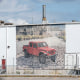 A view of the Jeep Plant front between a chain link on a fence