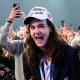 Supporters cheer in a large crows wearing Trump hats and shirts