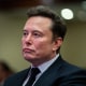 Elon Musk listens as President-elect Donald Trump speaks