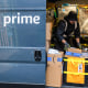 A worker sorts boxes inside an Amazon delivery van