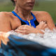 Female athlete taking ice bath for recovery after hard training session