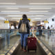 A traveler walks on a moving walkway.