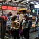 Customers wait in line at a Starbucks at Miami International Airport.