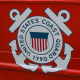 A detail view of the coast guard seal on the side of a ship