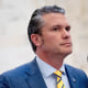 Pete Hegseth and his wife, Jennifer Rauchet, walk through the Russell Senate Office building on Capitol Hill on Dec. 3, 2024.