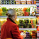 Fruit is displayed as a woman shops in a supermarket