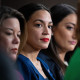 Rep. Alexandria Ocasio-Cortez, D-N.Y., listens to House Speaker Nancy Pelosi at the Capitol in 2021. 