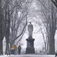 Image: Snow falls as a couple walks along the Commonwealth Avenue Mall in the Back Bay neighborhood of Boston on Dec. 20, 2024.