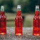 Red soda in three bottles 