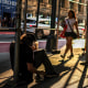 A homeless man sits on the ground 