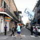 A man runs with a "Love" flag down Bourbon Street on Jan. 2, 2025 in New Orleans.