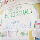 A sign says "We are bilingual! Somos bilingues!" on a classroom board