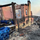 A photo of fire damaged house and gate ruins