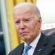 Joe Biden sits at his desk in the oval office