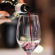 An exhibitor pours a glass of red wine