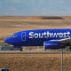 A Southwest Airlines plane taxis down a runway for take off at Denver International Airport.