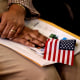 A new citizen holds an American flag during a naturalization ceremony 