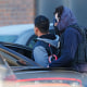 Law officials escort a suspect during a raid of an apartment complex in Denver. 