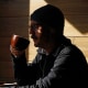 A customer drinks coffee at a shop in New York City