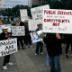 Attendees hold signs during a rally at Houston City Hall on Monday, Feb. 17.  