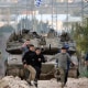 Israeli tanks drive towards the occupied West Bank of Jenin camp on Sunday, Feb. 23, 2025.