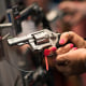 An attendee handles a Smith & Wesson pistol