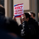 Demonstrators outside the Department of Veterans Affairs headquarters in Washington on Feb. 13, 2025.