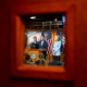 Pete Aguilar, Hakeem Jeffries, and Katherine Clark seen from a door window.