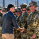 Defense Secretary Pete Hegseth shakes hands with an Army soldier 