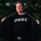 Elon Musk with a shirt that says "DOGE" 