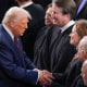 President Donald Trump greets justices of the Supreme Court, from left, Elena Kagan, Bret Kavanaugh, and Amy Coney Barrett, before addressing a joint session of Congress on March 4, 2025.