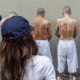 Secretary of Homeland Security Kristi Noem looks at prisoners in Tecoluca, El Salvador
