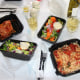 Take out containers set on a table for dinner