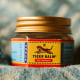 A small jar of Tiger balm, a popular traditional ointment for relief of muscle aches.
