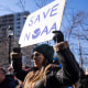 Demonstrators attend a rally outside National Oceanic and Atmospheric Administration headquarters to oppose the recent worker firings in Silver Spring, Md., on March 3, 2025. 
