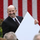 Secretary of Commerce Howard Lutnick holds a chart as  President Donald Trump delivers remarks on tariffs in the White House Rose Garden 