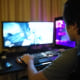 A boy plays a game on a computer.
