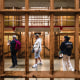 Visitors walk through a cell block of a prison