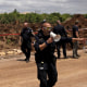 Police inspect the scene after a ballistic missile fired from Yemen by the Houthis struck a field near Israel's Ben Gurion Airport on May 4, 2025.