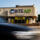 A car passes by Rite Aid store with a "Store Closing" sign.
