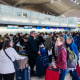  People wait in line for a delayed flight at Newark International Airport