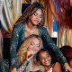 Beyonce on stage with Rumi and Blue Ivy, dancers surround them