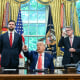 Trump, center, speaks to reporters.