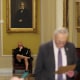 U.S. Senator Fetterman sits in the hallway behind the weekly Senate Democrat press conference at Capitol