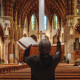 A person prays with their hands in the air