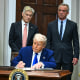 Image: President Donald Trump signs an executive order on prescription drug prices