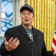Elon Musk speaks as US President Donald Trump looks on in the Oval Office