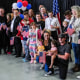 A group of people pose with American flags