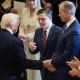 President Donald Trump shakes hands with House Speaker Rep. Mike Johnson and Senate Majority Leader John Thune (R-SD)
